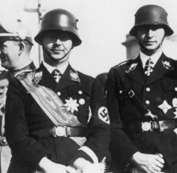 Munich 7/10/1900 – (suicide) near Lüneburg 23/5/1945.
Himmler (centre), Reinhard Heydrich and the head of the security police Kurt Daluege in the background.